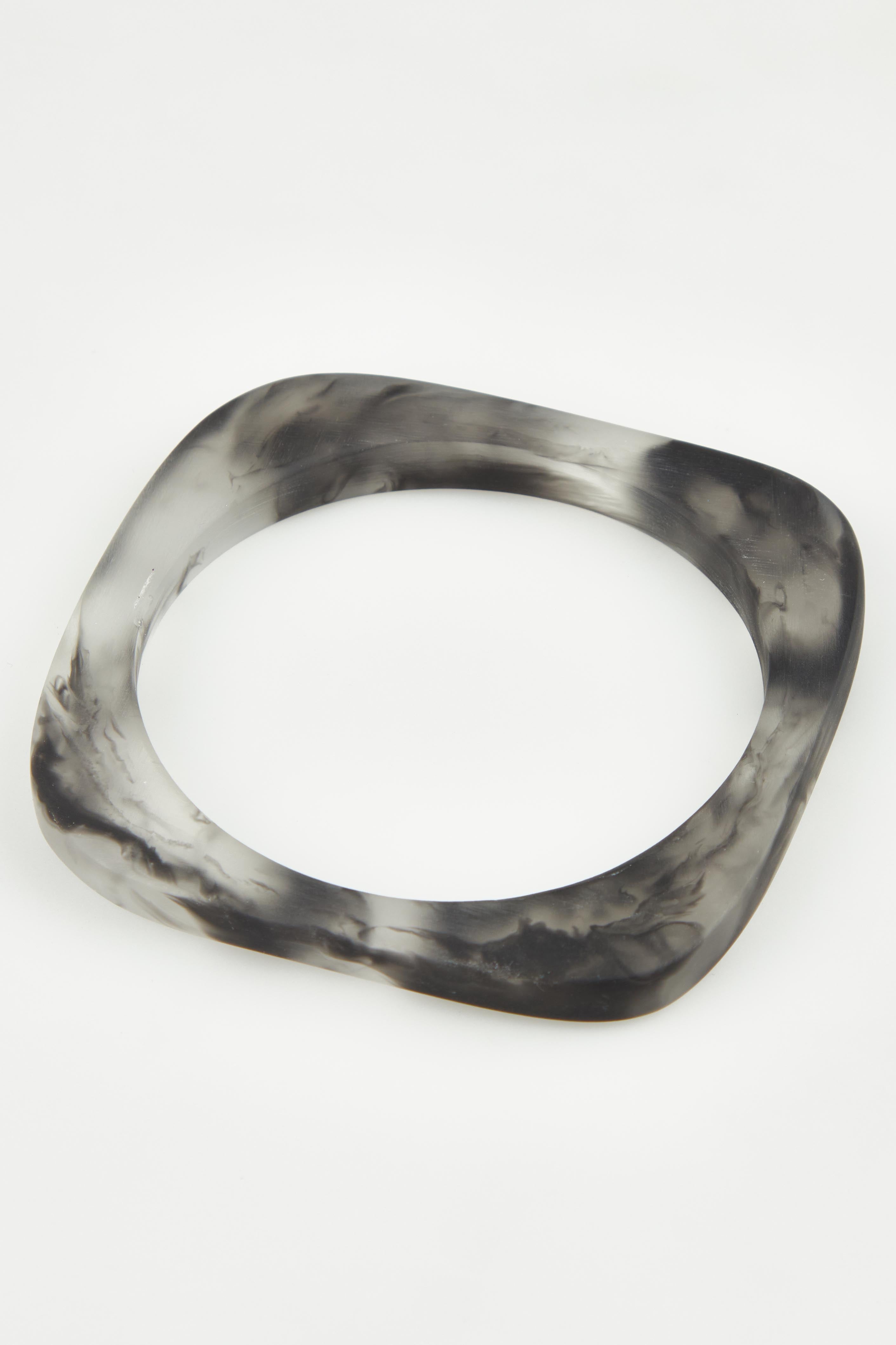 A model wearing the Square Resin Stacking Bangle in colour Black (Black), from the front, showing the whole outfit