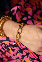 A model wearing the Sybil Gold Link Bracelet in colour Gold (Metallics), from the front, cropped image