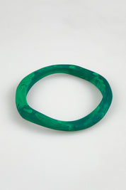 A model wearing the Wave Resin Stacking Bangle in colour Green (Green), from the front, showing the whole outfit