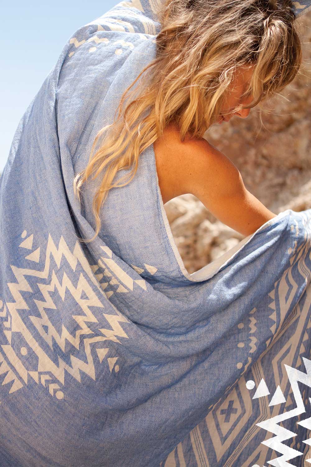 A model wearing the Hammamas Aztec Cotton Towel in colour AztecBlue (Blue), from the front, showing the whole outfit