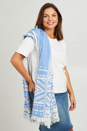 Model Monique wearing the Hammamas Aztec Cotton Towel in colour AztecBlue (Blue), from the front, cropped image