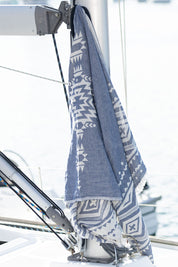 A model wearing size OneSize of the Hammamas Aztec Towel in colour Navy (Blue), from the front, showing the whole outfit