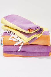 A model wearing the Hammamas Clash Cotton Towel in colour DaisyOran, from the front, showing the whole outfit