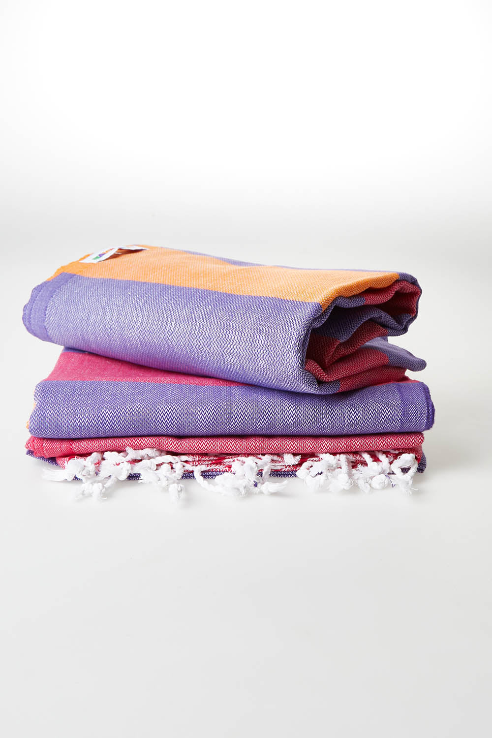 A model wearing size OneSize of the Hammamas Clash Towel in colour Candyiris (Pink), from the front, showing the whole outfit