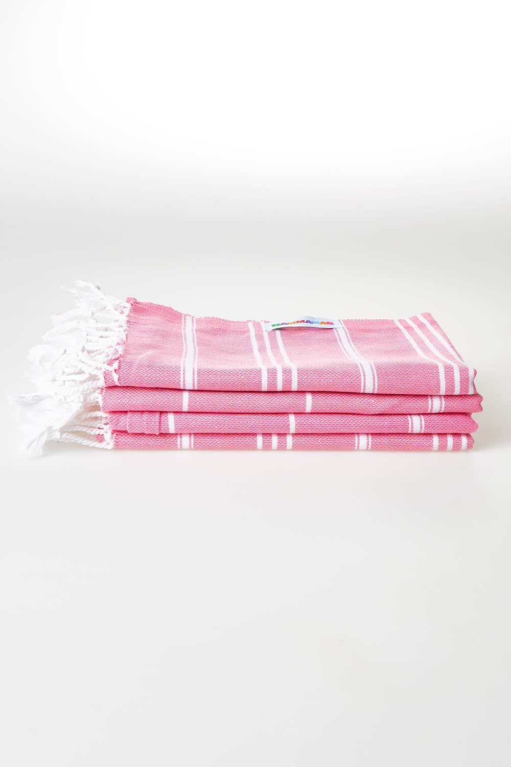 A model wearing size OneSize of the Hammamas Cotton Bubs Towel in colour Wtermelon (Pink), from the front, showing the whole outfit