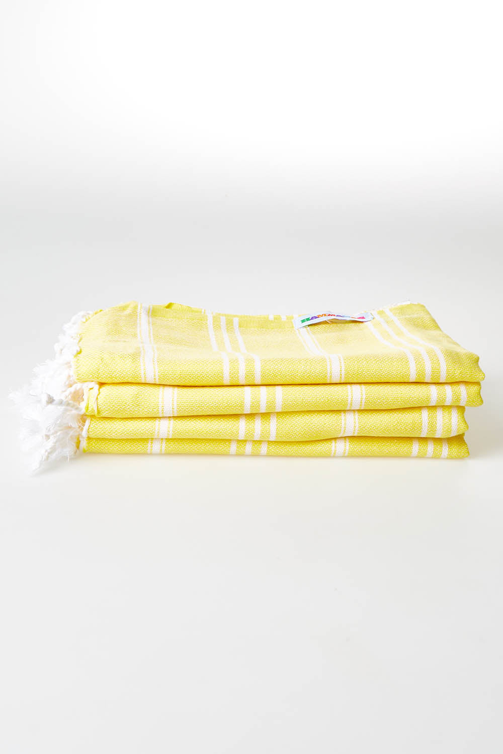 A model wearing size OneSize of the Hammamas Cotton Bubs Towel in colour Daisy, from the front, showing the whole outfit