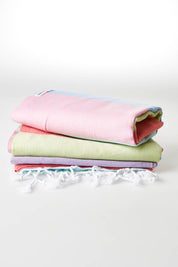 A model wearing size OneSize of the Hammamas Splice Cotton Towel in colour Dolce (Green), from the front, showing the whole outfit