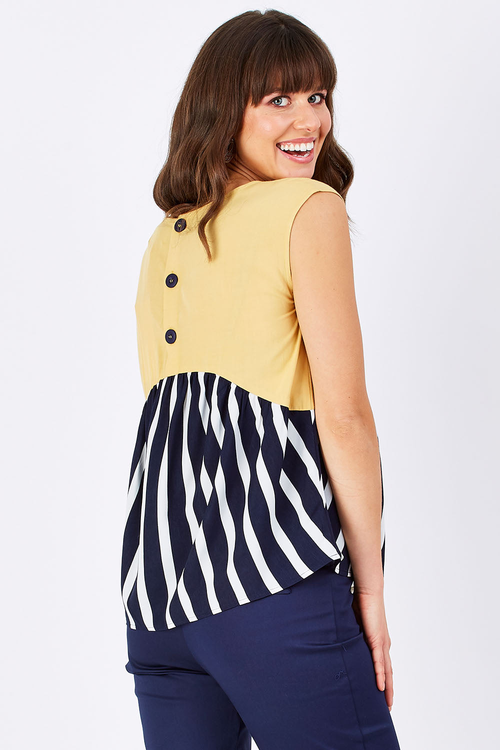 Model Edith wearing size 10 of the Sleeveless Tank in colour Sunset (Blue), from the back