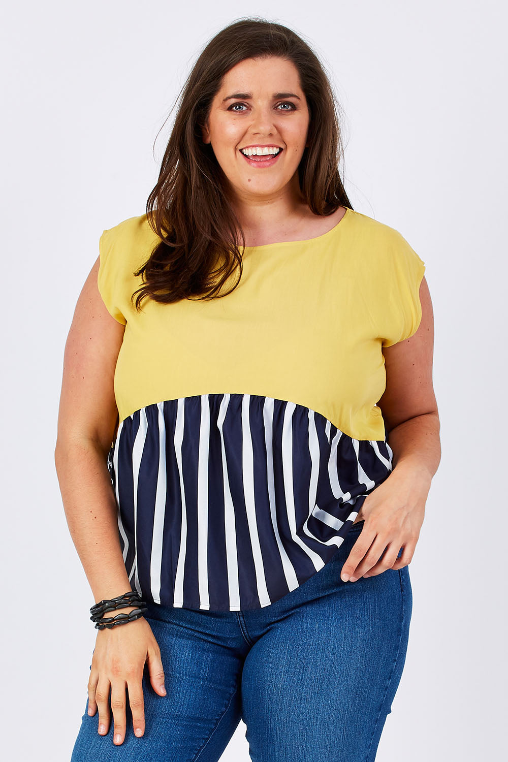 Model Mae wearing size 16 of the Sleeveless Tank in colour Sunset (Blue), from the front, cropped image