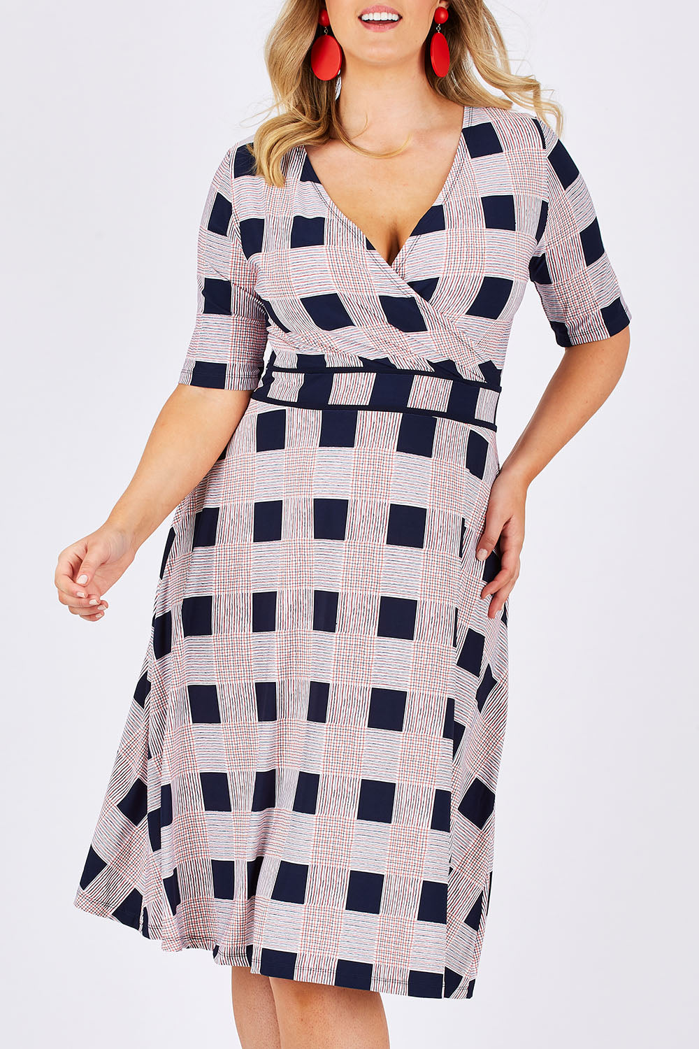 Model Jess wearing size 14 of the Faux Jersey Wrap in colour Checkers (White), from the front, cropped image