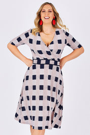 Model Jess wearing size 14 of the Faux Jersey Wrap in colour Checkers (White), from the front, cropped image