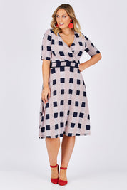 Model Jess wearing size 14 of the Faux Jersey Wrap in colour Checkers (White), from the front, showing the whole outfit