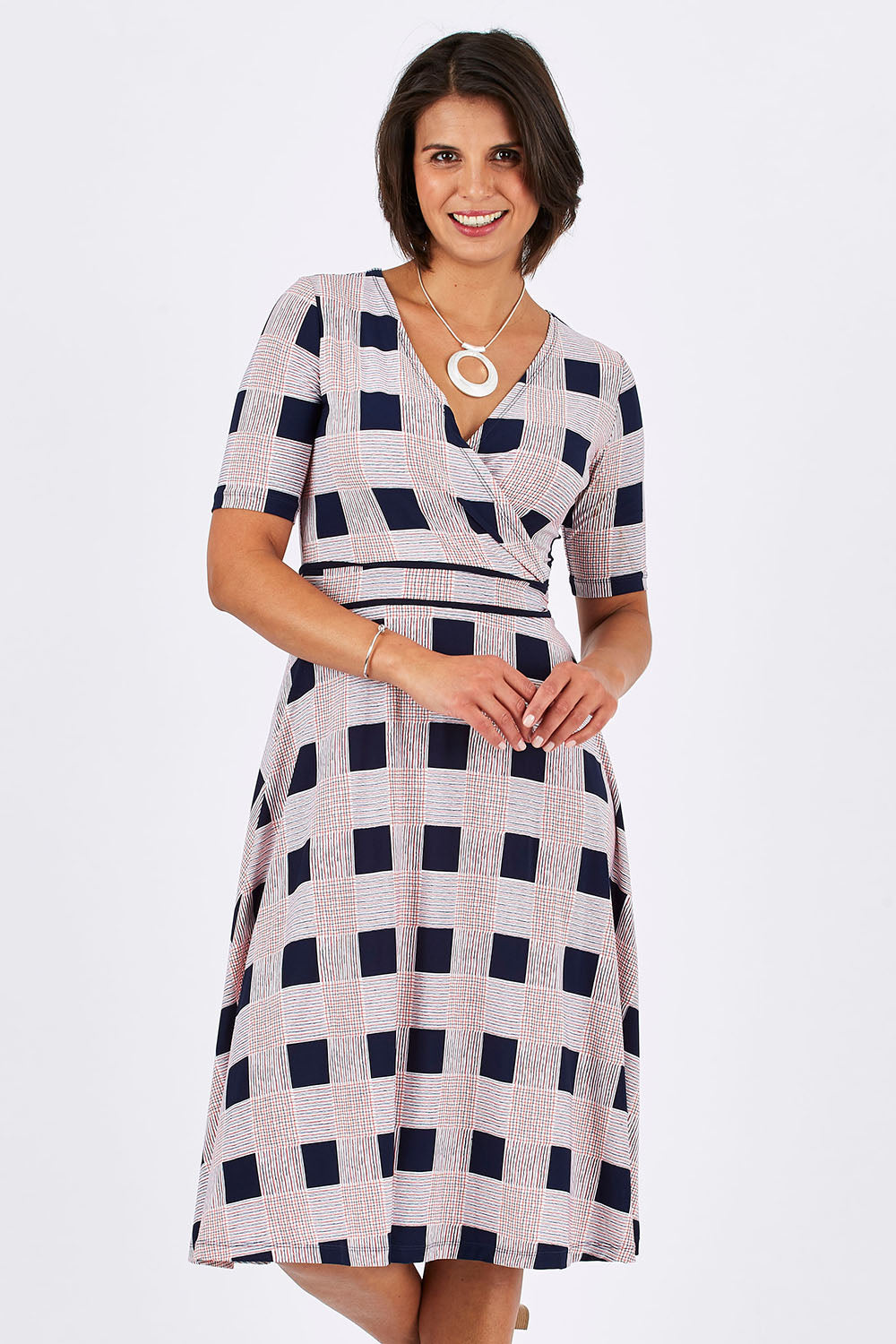 Model Thais wearing size 10 of the Faux Jersey Wrap in colour Checkers (White), from the front, cropped image
