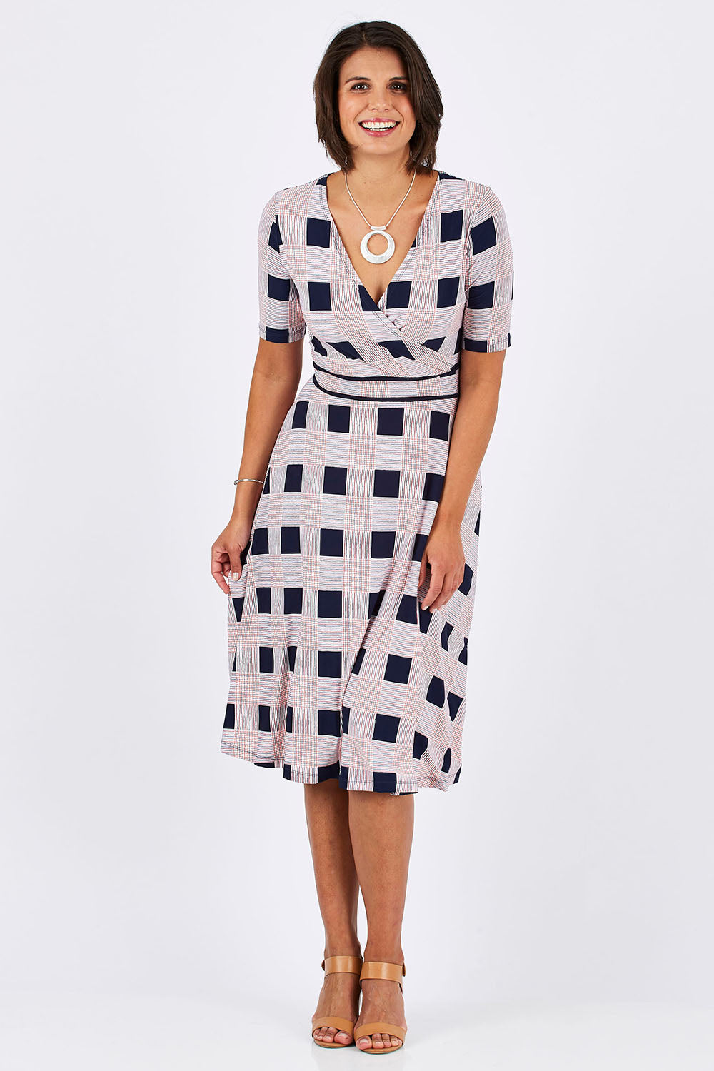 Model Thais wearing size 10 of the Faux Jersey Wrap in colour Checkers (White), from the front, showing the whole outfit