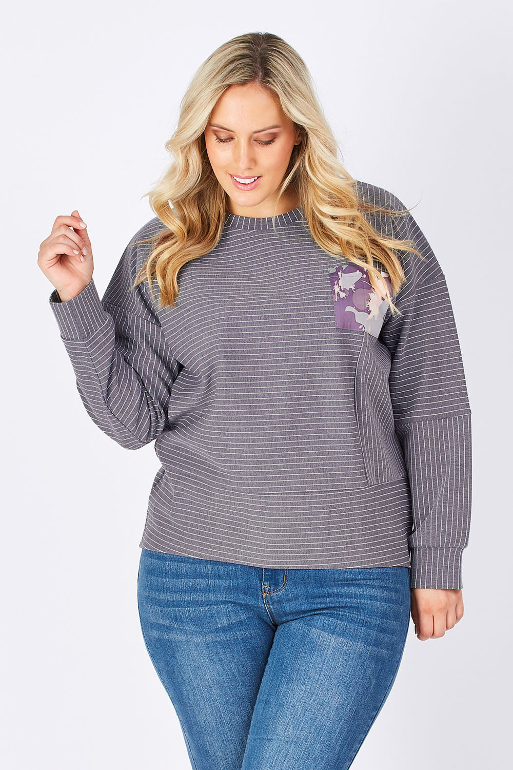 Model Jess wearing size 14 of the Contrast Stripe Sweater in colour Pockets (Grey), from the front, cropped image