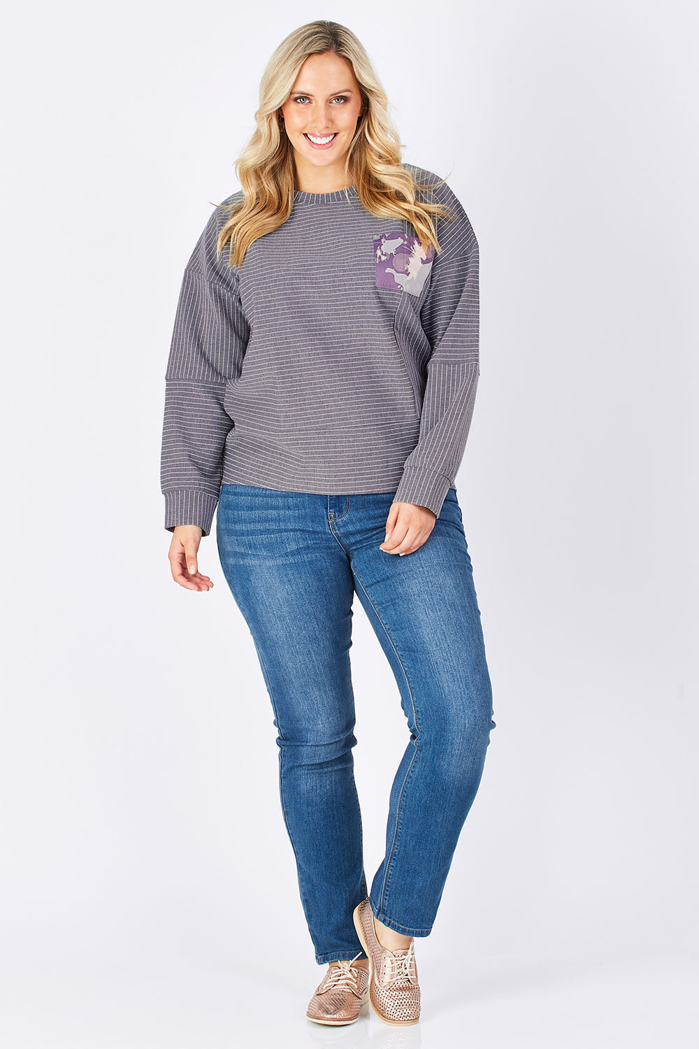 Model Jess wearing size 14 of the Contrast Stripe Sweater in colour Pockets (Grey), from the front, showing the whole outfit