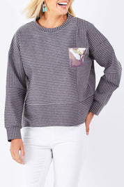 Model Jude wearing size 10 of the Contrast Stripe Sweater in colour Pockets (Grey), from the front, cropped image