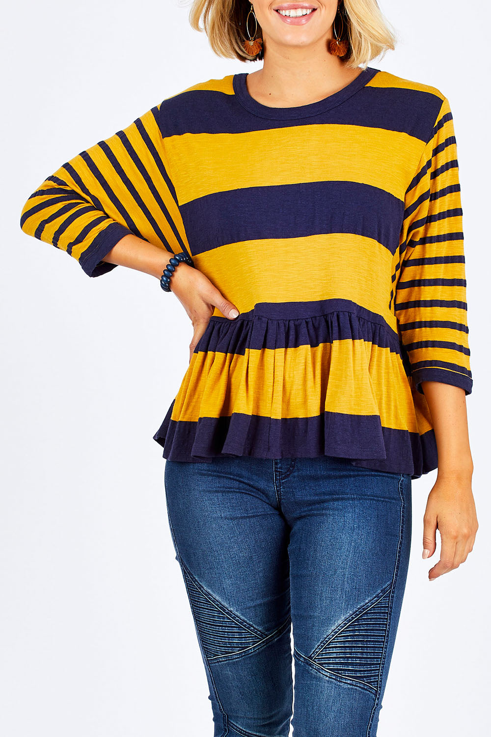 Model Emma wearing size 10 of the Hem Frill Stripe Top in colour SoFrilled (Blue), from the front, cropped image