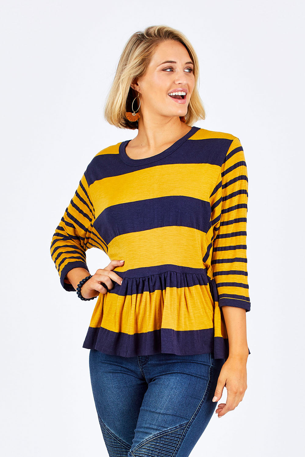 Model Emma wearing size 10 of the Hem Frill Stripe Top in colour SoFrilled (Blue), from the front, cropped image