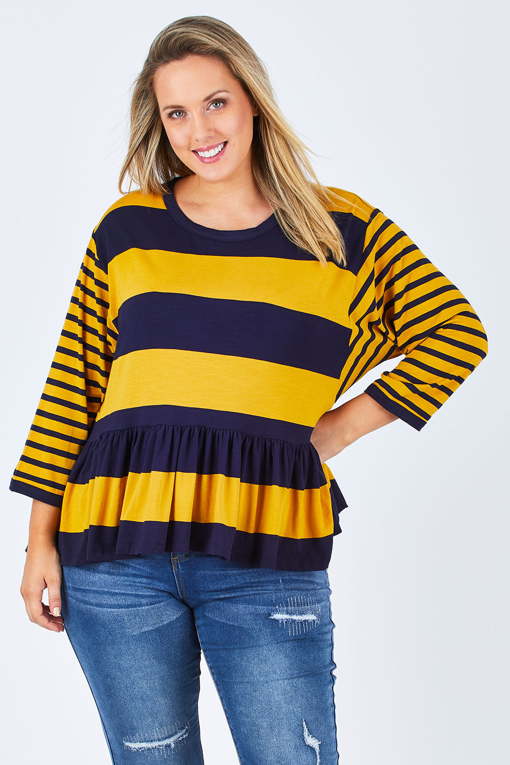 Model Jess wearing size 14 of the Hem Frill Stripe Top in colour SoFrilled (Blue), from the front, cropped image