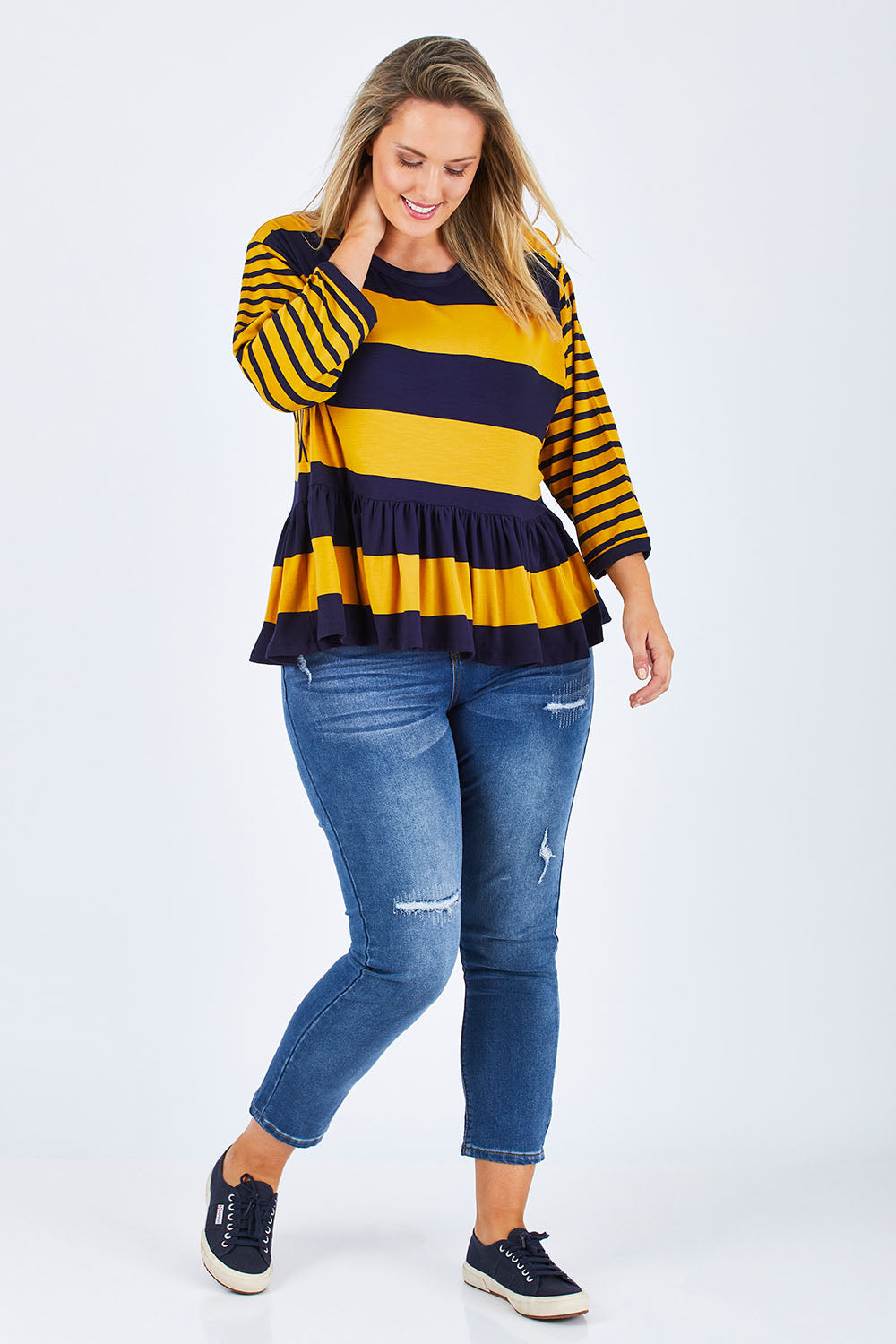 Model Jess wearing size 14 of the Hem Frill Stripe Top in colour SoFrilled (Blue), from the front, showing the whole outfit