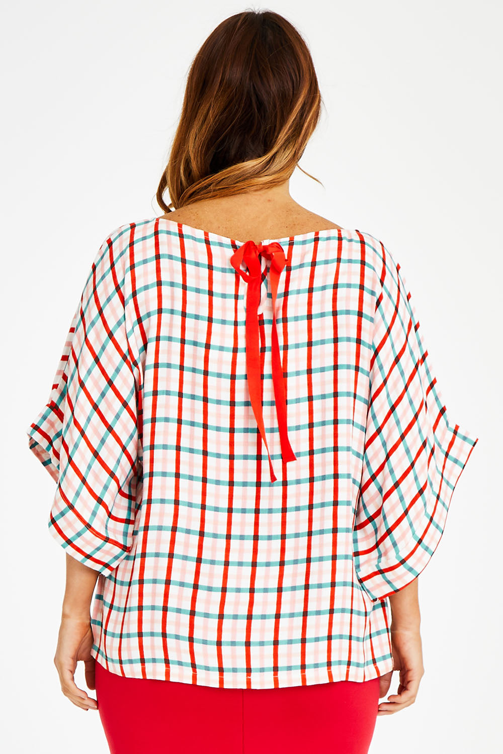 Model Laura wearing size 14 of the Tie Back Bell Sleeve Top in colour Check (White), from the back