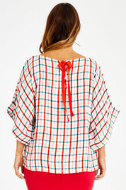 Model Laura wearing size 14 of the Tie Back Bell Sleeve Top in colour Check (White), from the back