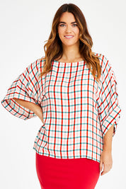 Model Laura wearing size 14 of the Tie Back Bell Sleeve Top in colour Check (White), from the front, cropped image
