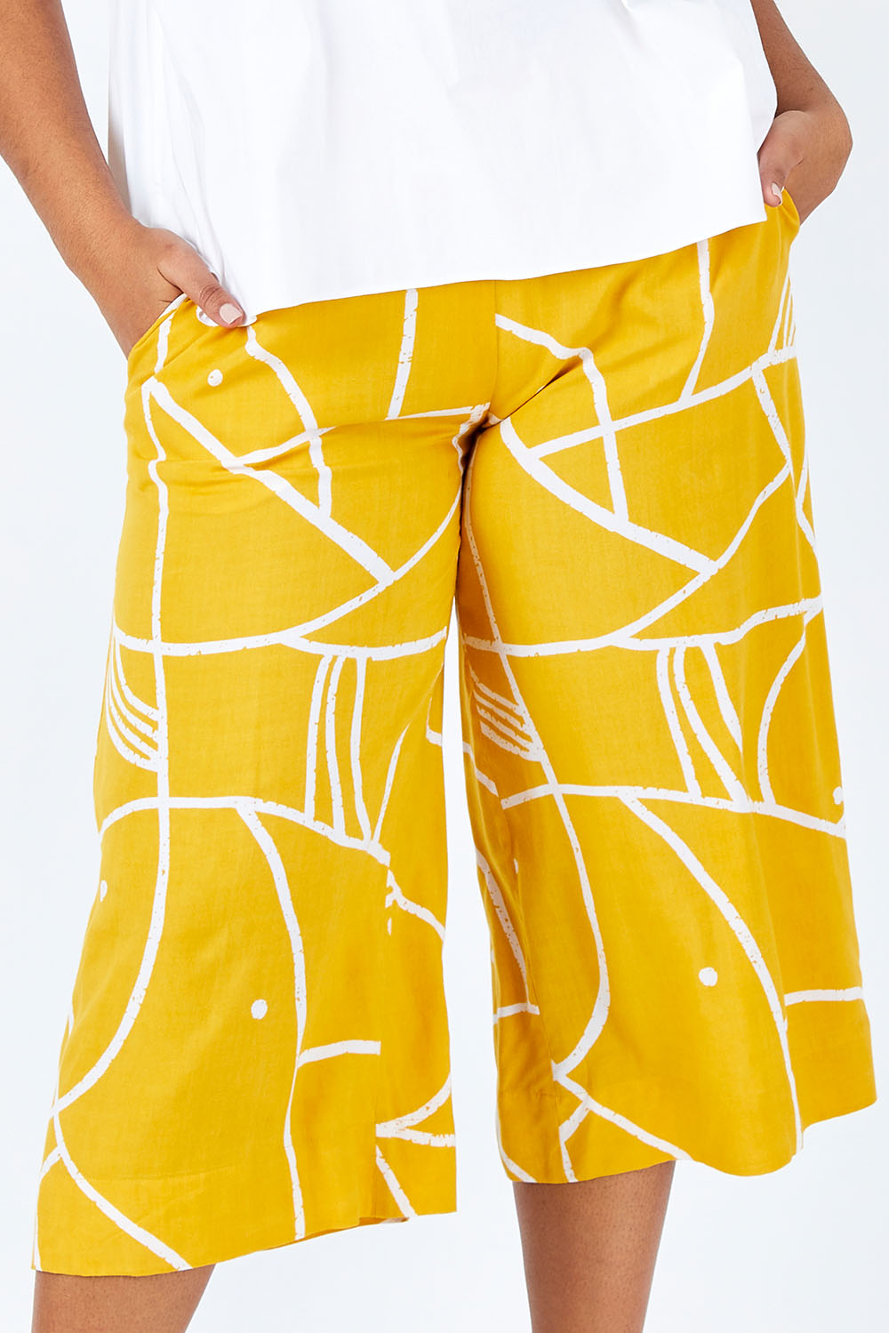 Model Shanaya wearing size 14 of the Geo Print Pant in colour Geo, from the front, cropped image