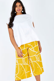 Model Shanaya wearing size 14 of the Geo Print Pant in colour Geo, from the front, cropped image