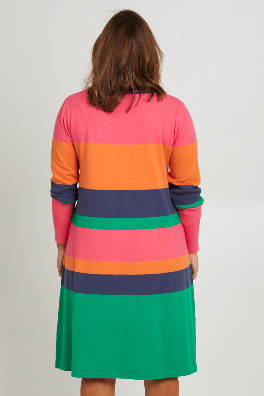 Model Monique wearing size L of the Knit Stripe Dress in colour Multihues (Pink), from the back