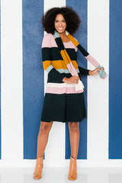 Model Schanez wearing size S of the Knit Stripe Dress in colour Mixstripe (Green), from the front, showing the whole outfit