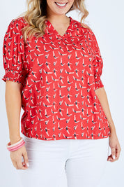 Model Jess wearing size 14 of the Printed V Neck Top in colour Diving (Pink), from the front, cropped image