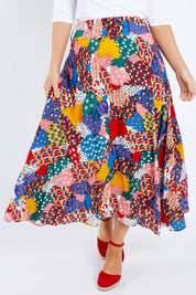 Model Laura wearing size 14 of the Patchwork Maxi Skirt in colour Patched (Red), from the front, cropped image