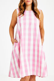 Model Laura wearing size 14 of the Gingham Swing Dress in colour Gingham (Pink), from the front, cropped image