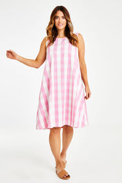 Model Laura wearing size 14 of the Gingham Swing Dress in colour Gingham (Pink), from the front, showing the whole outfit