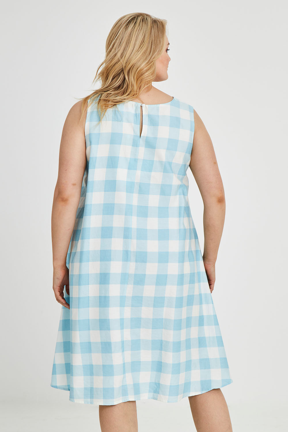 Model Keeara wearing size 16 of the Gingham Swing Dress in colour Gingham (Blue), from the back