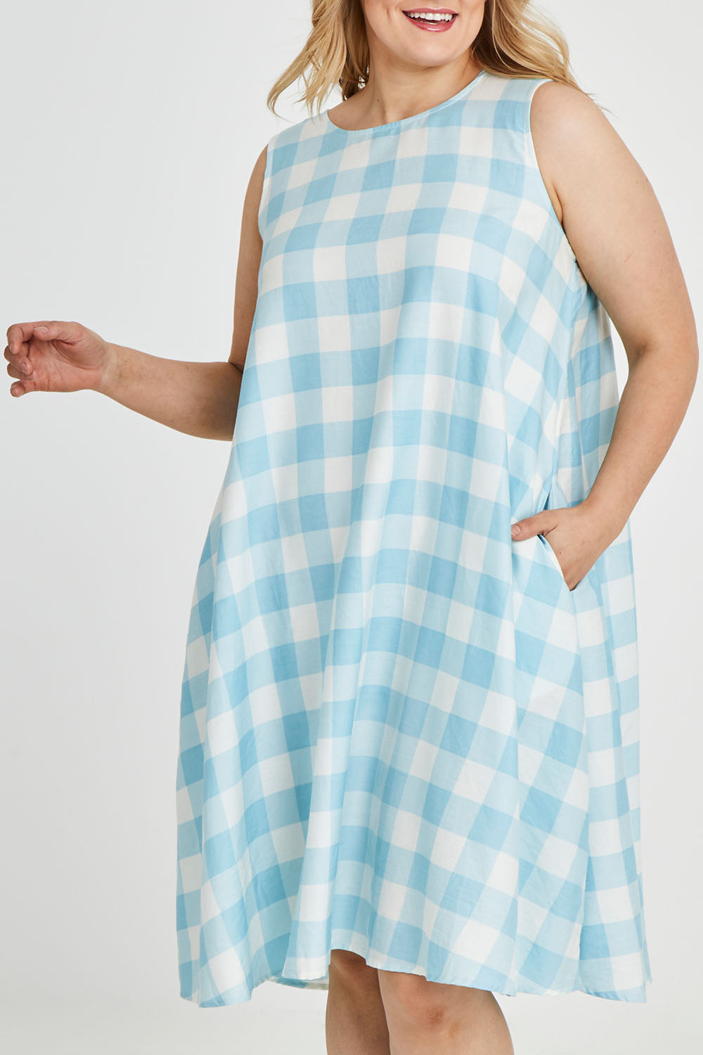 Model Keeara wearing size 16 of the Gingham Swing Dress in colour Gingham (Blue), from the front, cropped image
