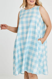Model Keeara wearing size 16 of the Gingham Swing Dress in colour Gingham (Blue), from the front, cropped image