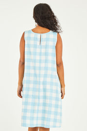 Model Noli wearing size 14 of the Gingham Swing Dress in colour Gingham (Blue), from the back