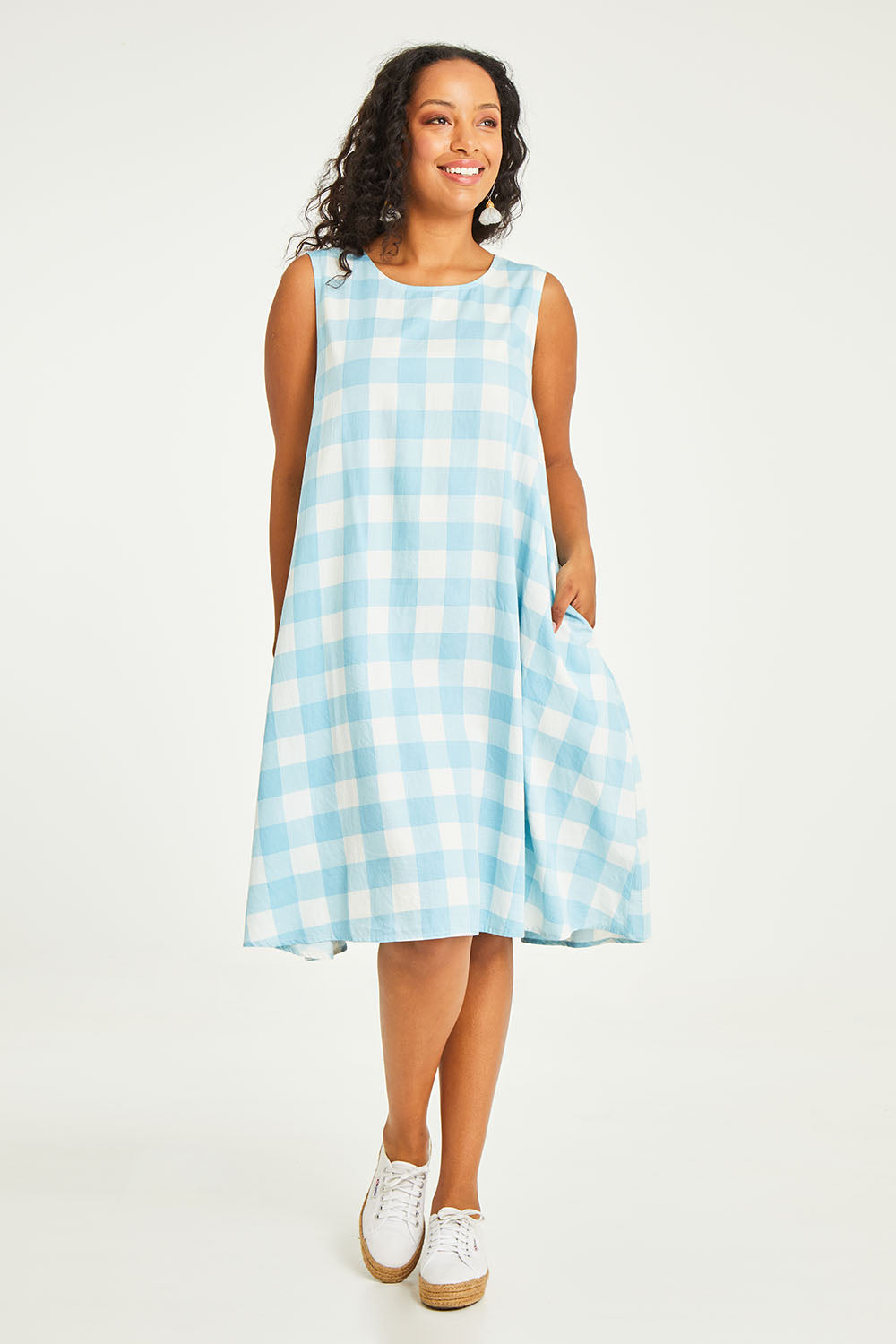 Model Noli wearing size 14 of the Gingham Swing Dress in colour Gingham (Blue), from the front, showing the whole outfit