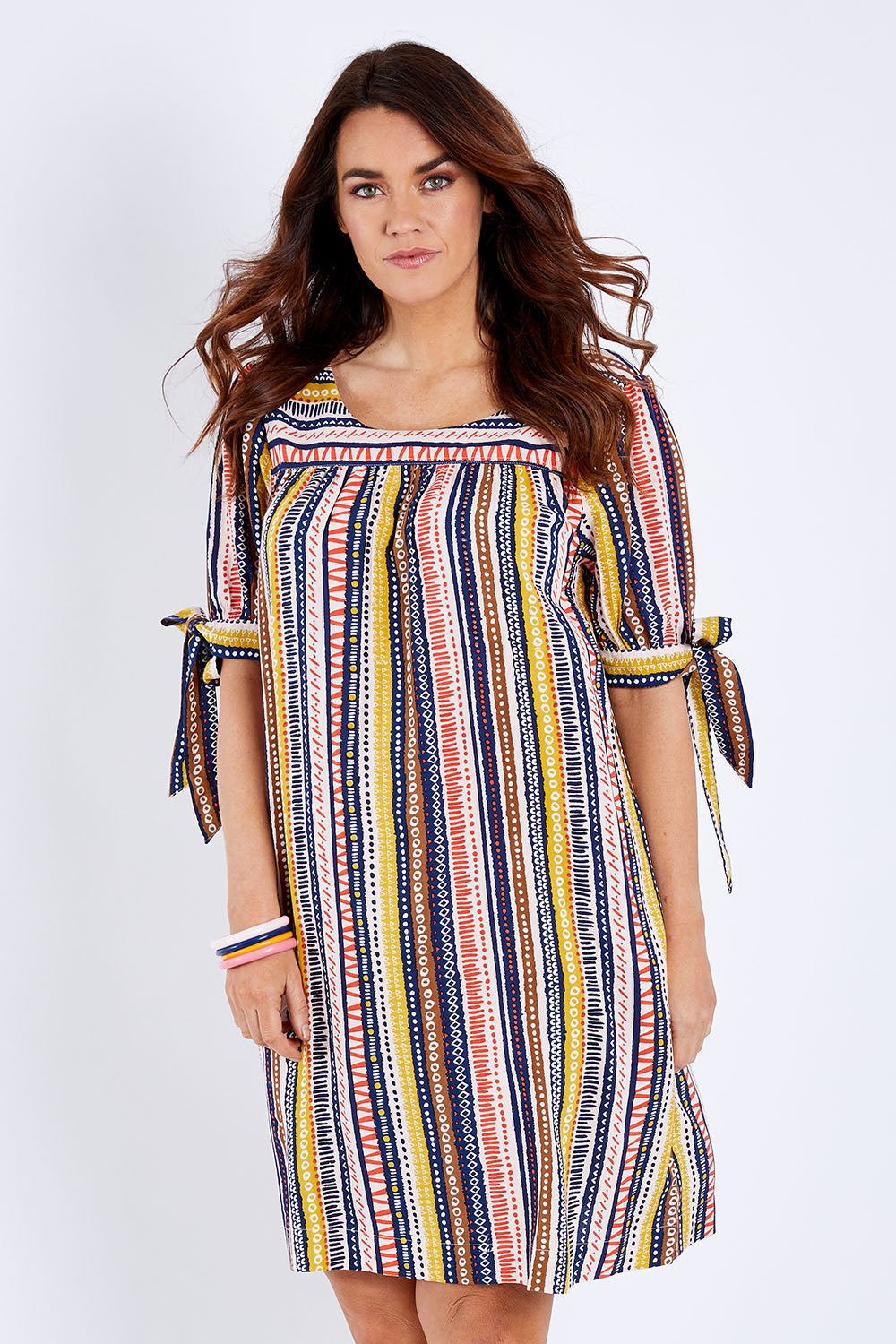 Model Laura wearing size 12 of the Striped Tie Sleeve Dress in colour Tribal (Blue), from the front, cropped image