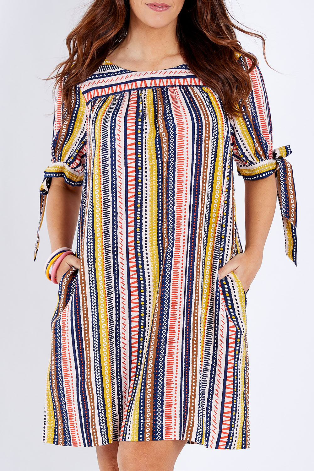 Model Laura wearing size 14 of the Striped Tie Sleeve Dress in colour Tribal (Blue), from the front, cropped image