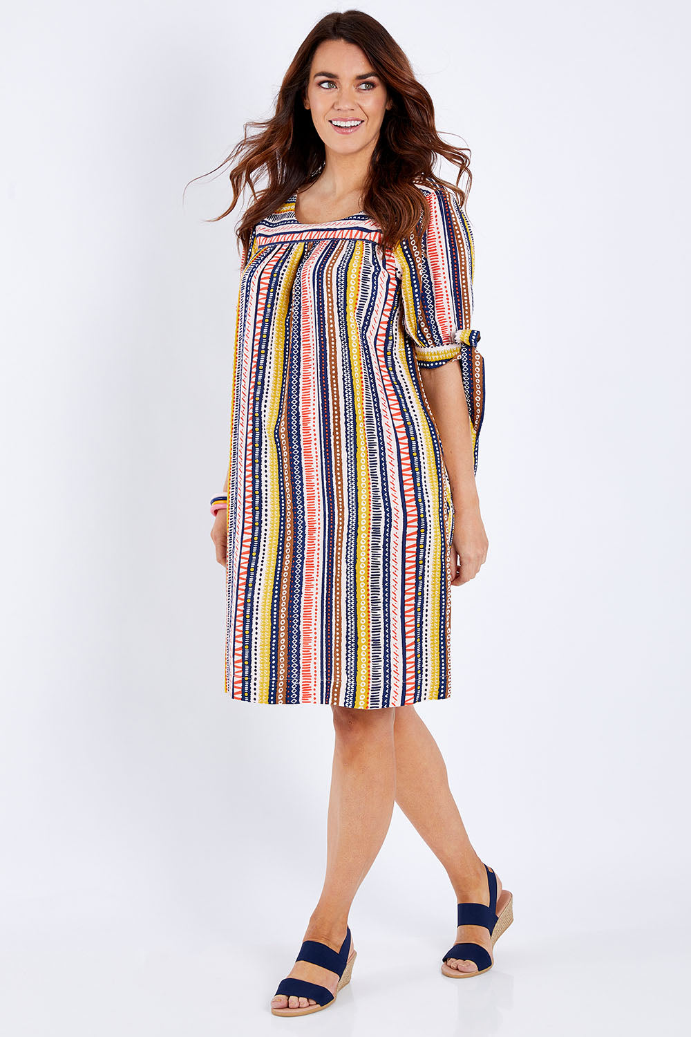 Model Laura wearing size 14 of the Striped Tie Sleeve Dress in colour Tribal (Blue), from the front, showing the whole outfit