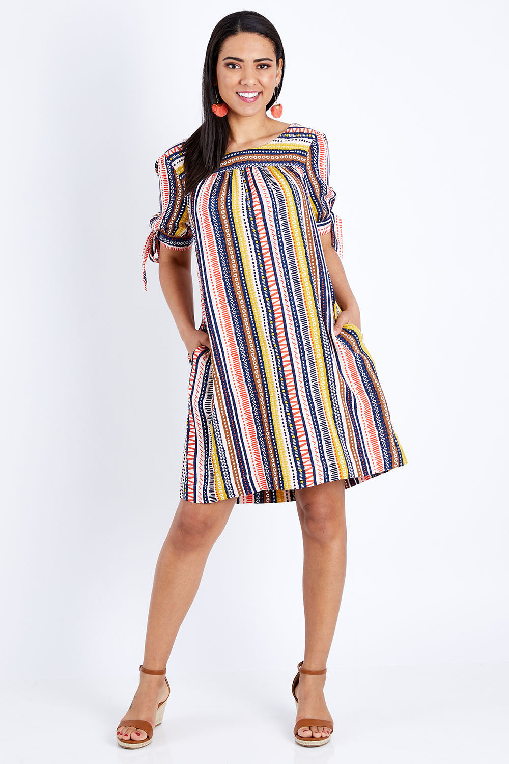 Model Pamela wearing size 10 of the Striped Tie Sleeve Dress in colour Tribal (Blue), from the front, showing the whole outfit