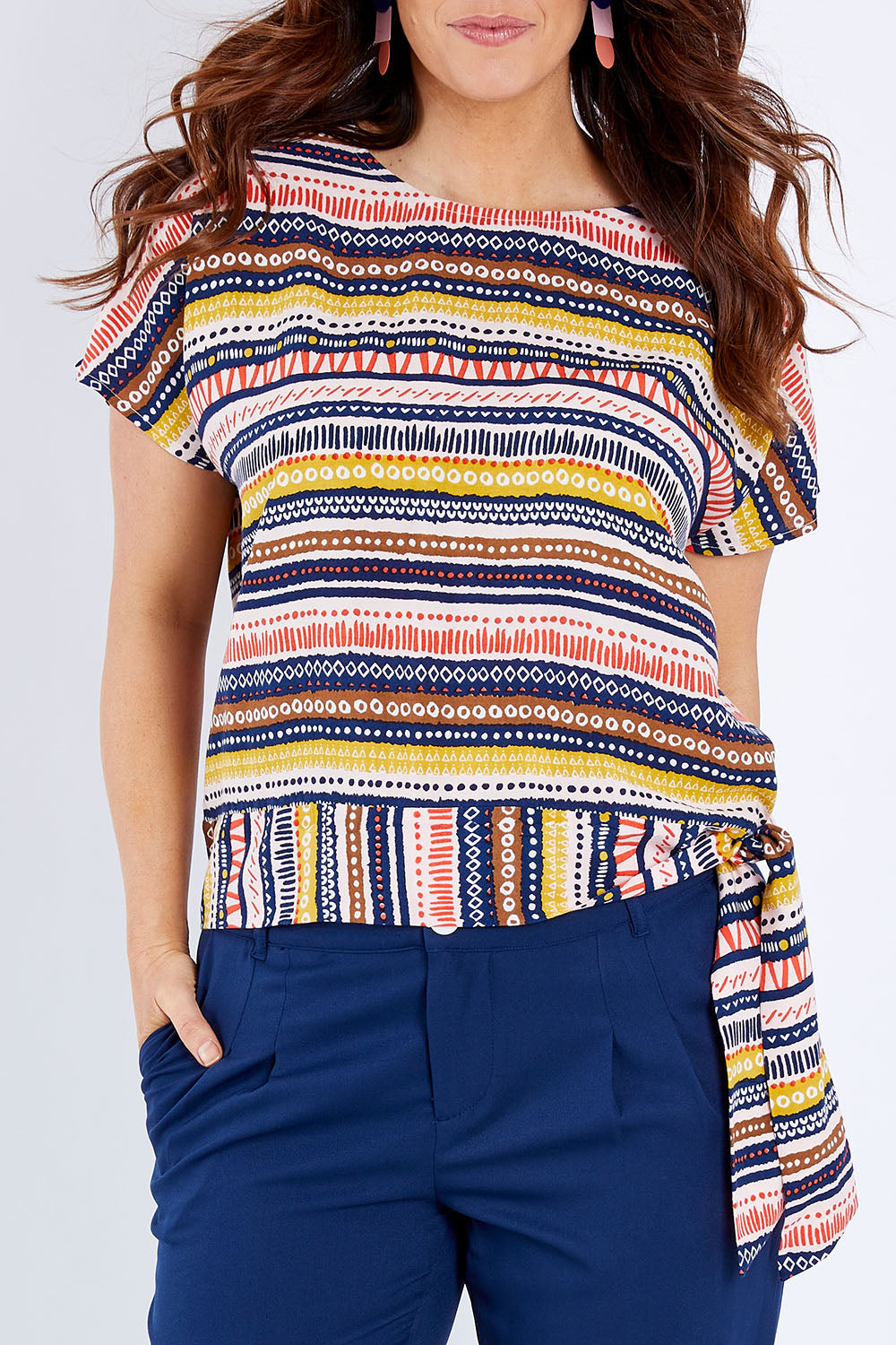 Model Laura wearing size 14 of the Striped Tie Waist Top in colour Tribal (Blue), from the front, cropped image
