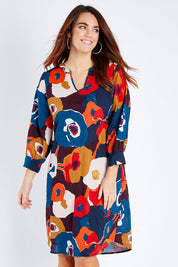 Model Laura wearing size 14 of the Long Sleeve Relaxed Fit Dress in colour Autfloral (Blue), from the front, cropped image
