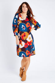 Model Laura wearing size 14 of the Long Sleeve Relaxed Fit Dress in colour Autfloral (Blue), from the front, showing the whole outfit