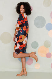 Model Schanez wearing size 10 of the Long Sleeve Relaxed Fit Dress in colour Autfloral (Blue), from the front, showing the whole outfit