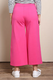 Model Georgiel wearing size 10 of the Wide Leg Ponte Pant – Pink in colour Pink, from the back